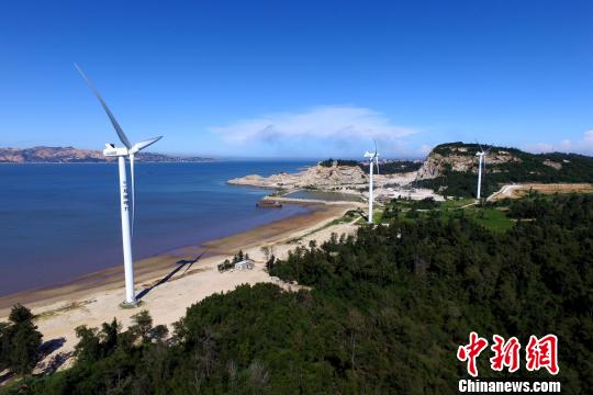 沿海滩而建的风力发电机。　王东明 摄